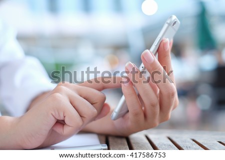 close up woman's hand hold mobile phone device:focus on girl work play read call text type on smartphone concept:teen people innovation technology telecommunication.teenager reply response chatting