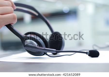 close up headset of call centre hotline at computer office room:operator helpline job:help-desk consult service.blur of assignment,business,technology concept:help desk support service worldwide.