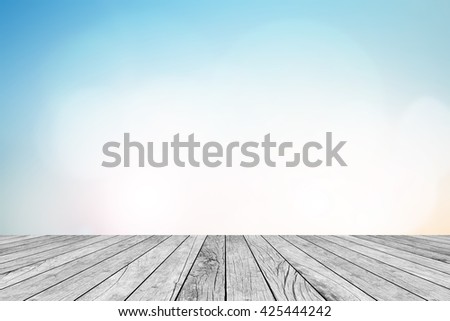 blurred natural blue sky gradient backdrop wall with old white wood colored background texture tabletop:rustic aged tiles wooden with blur pastel cool wallpaper.advertise,show your products on display