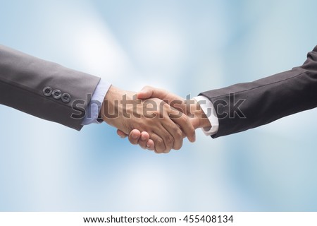 close up business man handshake together on blur background in :agreement,accept,approve financial cooperative concept.improve/development.trust,goal,team,hand,shake:international  investment:success