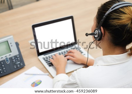 close up call centre woman working in office room:focus on headphone of asian girl response answer customer question or partner concept:people technology innovation:service support business:operation