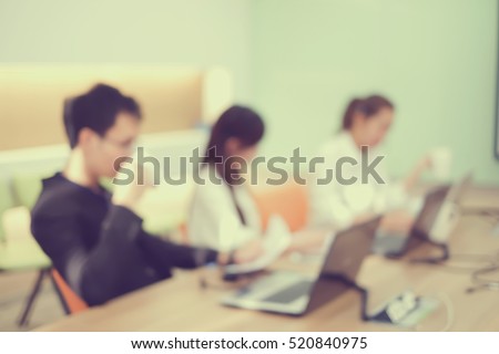 abstract blurred employee work in office room:group of teamwork asian staff accountant doing accounting job together:collaboration people concept.human resource department:take care customer service