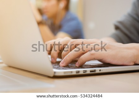 Close up student man hand type on keyboard notebook for doing homework or project:employee work on laptop research data information or search engine optimization:programmer operate binary code concept