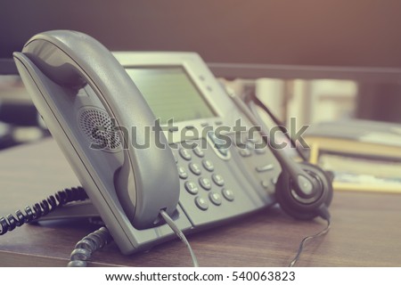 close up soft focus on telephone devices at office deskcustomer service support concept:communication technology:vintage filter color tone effect.