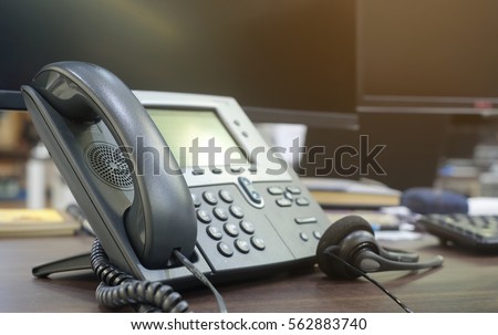 close up soft focus on telephone devices at office desk:customer service support concept:communication technology:vintage filter color tone effect.