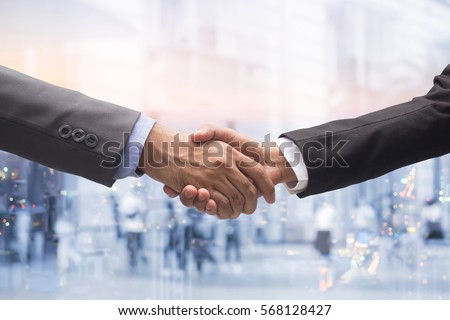 investor businessman handshake together on double exposure night city and walking people:agreement,accept,approve financial cooperative concept.accomplish goal:guarantee assurance::experience reliable