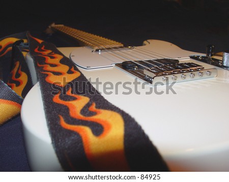 Cream-colored guitar with flamed strap.