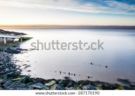 England, rocky Portishead coast line in long exposure capture.