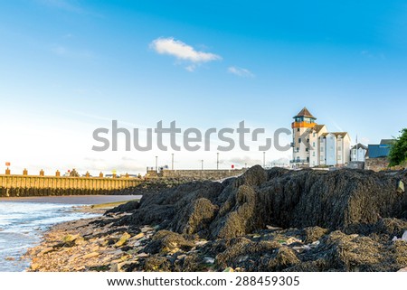 England, rocky Portishead coast line with lighthouse building.