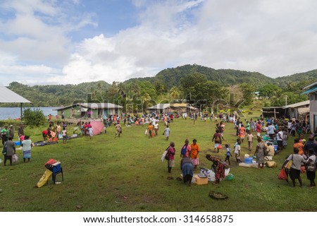 Batuna, Solomon Islands - May 28, 2015: People buying and selling food at the local market in the village of Batuna.