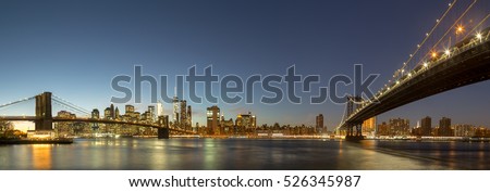 Skyline of Lower Manhattan with Brooklyn Bridge and Manhattan Bridge in the evening