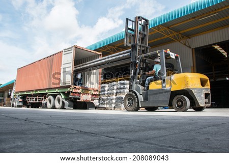 warehouse laborer team at unloading works with forklift loader