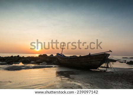 Fishing boat beached in the stone beach, sea, island