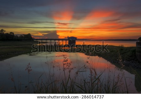 Reservoir Dokkrai(royal project of king bhumibol)  over sunset and Silhouettes landscape view sunset Water reflection at rayong,thailand