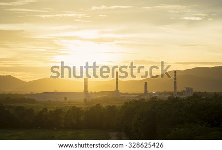 Silhouette of Oil and gas refinery at sunset