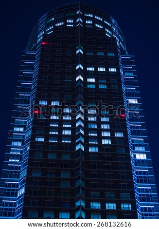 Urban lights: rhythm of lights in a modern facade in Frankfurt, Germany, at night