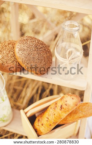 bread and milk in the gold wheat field
