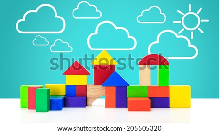 Building blocks toy over floor with cloud and sun background