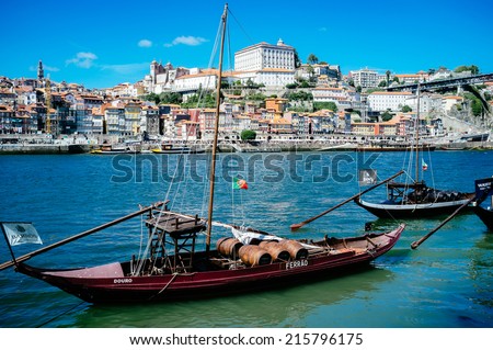 PORTO, PORTUGAL - AUGUST 6, 2014: Rabelo boats in front of historic city centre of Porto, Portugal, on August 6th 2014. Porto city centre is registered as a World Heritage Site by UNESCO since 1996.