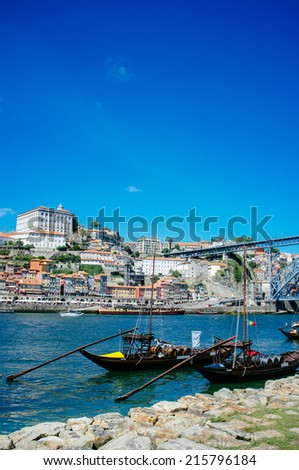 PORTO, PORTUGAL - AUGUST 6, 2014: Rabelo boats in front of historic city centre of Porto, Portugal, on August 6th 2014. Porto city centre is registered as a World Heritage Site by UNESCO since 1996.