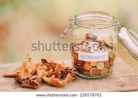 Money jar full of coins as a retirement fund.