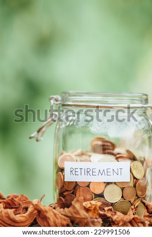 Money jar full of saved money for retirement