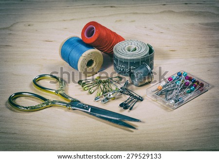 Still life with scissors, thread, pins. tool tailor. photo in old style image