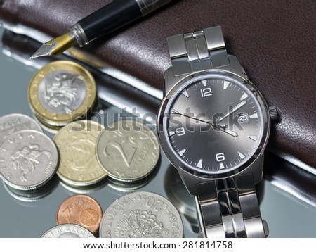 wrist watch  metal coins pen. notebook. close-up. Macro.