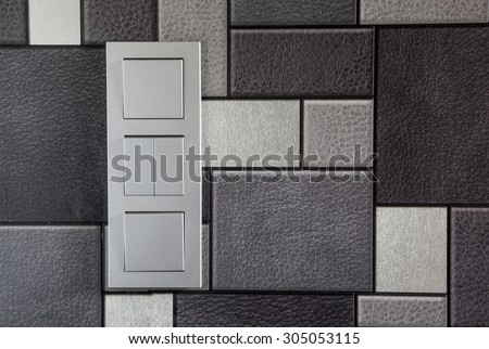 three electrical wall switch inside the house. on wallpaper background. device, closeup