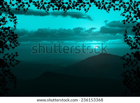 Beautiful sunset with cloud and mountain,tree foreground siluette frame,cyan color tone