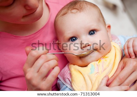 feeding baby. feeding baby food to aby