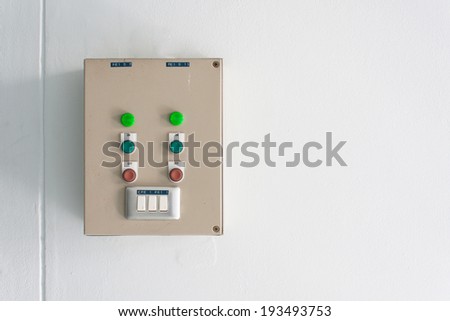 electrical control and light switch on white wall