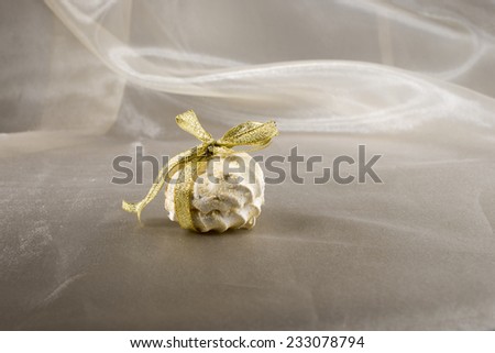 Marshmallows(zeffir) tied with golden ribbon on the golden background