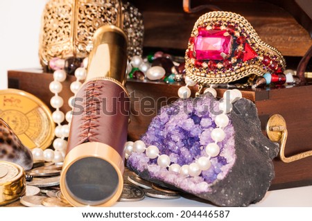 Pirate treasure chest with pearls, jewels, coins and glass