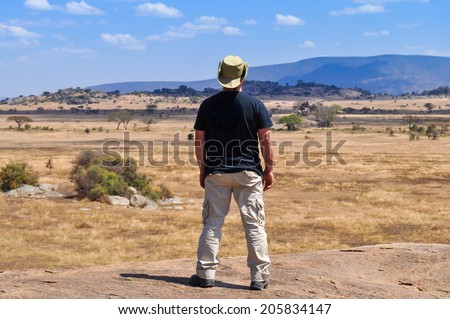 man from behind watching the horizon