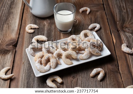Vanilla cookies and milk on a wooden table