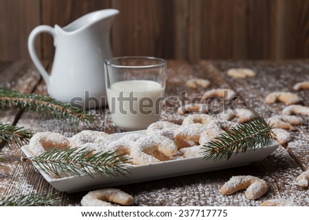 Vanilla cookies and milk on a wooden table