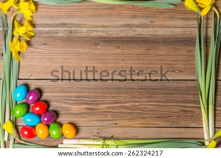 Easter eggs and flowers on a wooden table