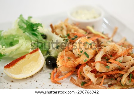 fried shrimp and squid with vegetables and sauce and lemon