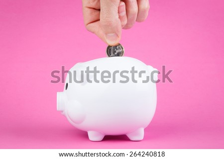 piggy bank and hand man throwing money