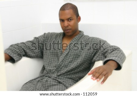 Man in bath robe in bath