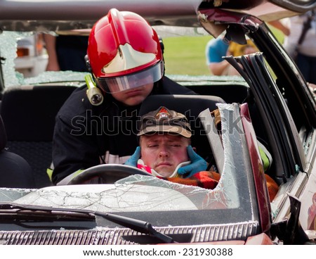 SZCZECIN, POLAND - JULY 08, 2014:Fire and Rescue Emergency crew removing a victim from at car crash training.