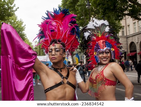 BERLIN, GERMANY - JUNE 21, 2014:Christopher Street Day. Crowd of people Participate in the parade celebrates gays, lesbians, and transgenders. Prominent in the image, elaborately dressed participants.