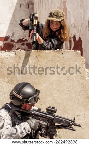 SZCZECIN, POLAND - MAY 31, 2014: Female with gun to point at soldier, during Historical reenactment.