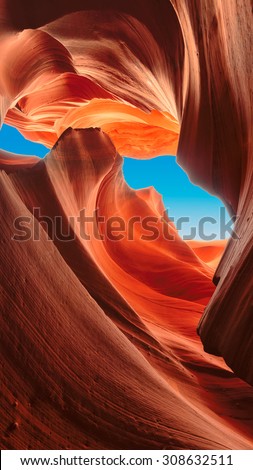 Up to blue sky in slot canyon. The Magic Antelope Canyon in the Navajo Reservation,  Arizona