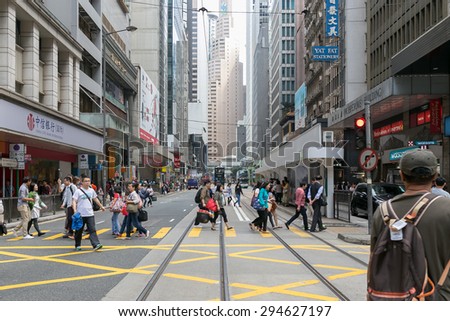 HONG KONG - MAR 29 : Tourists and locals walking across the street on Mar 29,2015 in HONG KONG