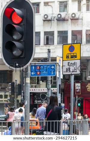HONG KONG - MAR 30 : Asian women are the traffic lights to cross the road on Mar 30,2015 in HONG KONG
