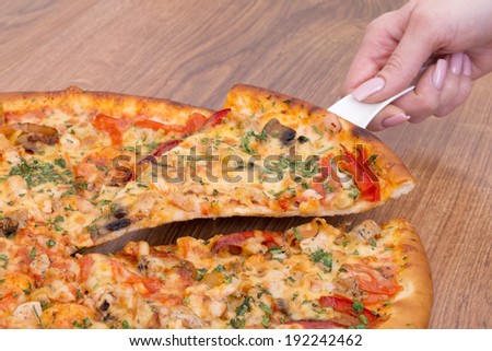Supreme pizza lifted slice