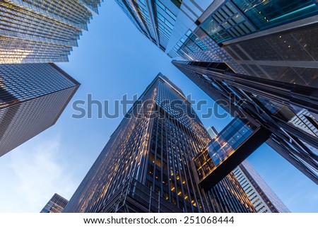 Office buildings stretch up to the blue sky in the financial district in downtown Toronto Ontario Canada.