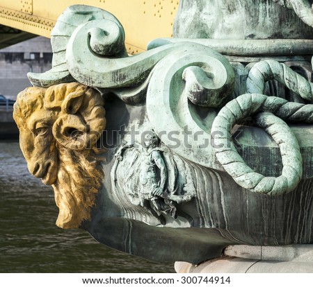 A close up of the golden ram head sculpture on Pont Mirabeau which crossing the Seine River in Paris France.